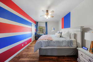 Bedroom with dark wood-style floors and a ceiling fan