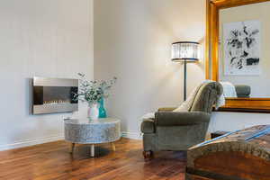 Sitting room with wood-type flooring