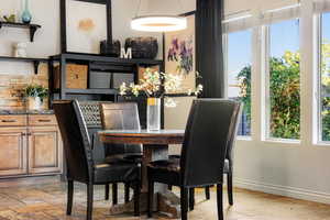 Dining area featuring stone tile floors