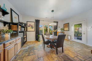 Dining area with stone tile flooring and healthy amount of natural light