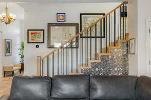 Living room featuring stairway and a chandelier
