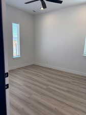 Unfurnished room with LVP flooring and a ceiling fan