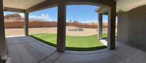 Fenced backyard with a covered patio area