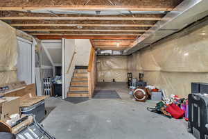 Unfinished basement featuring stairway