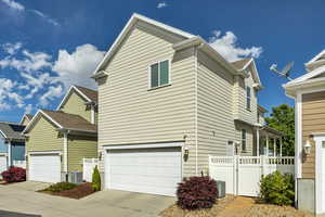 View of front of house featuring driveway, a gate, and an attached garage