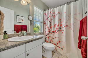 Bathroom featuring vanity and curtained shower