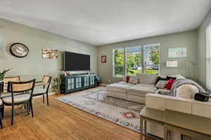 Living room with light wood finished floors and a textured ceiling