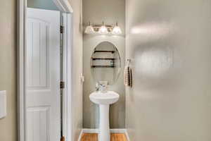 Bathroom with wood finished floors and baseboards