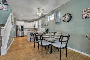 Dining room featuring ceiling fan, stairs, light wood-style floors, recessed lighting, and a textured ceiling