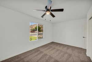 Empty room featuring carpet flooring and baseboards