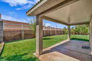 Fenced backyard featuring a patio