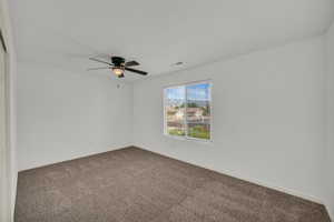 Spare room featuring carpet flooring and baseboards