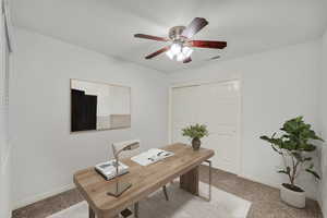 Office with light carpet and ceiling fan