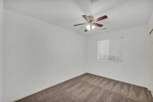 Unfurnished room featuring carpet floors and a ceiling fan
