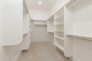 Walk in closet with light carpet