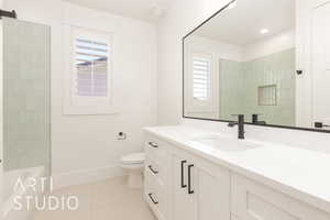 Bathroom with plenty of natural light, vanity, and tile patterned flooring
