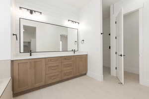 Full bath featuring double vanity and a shower