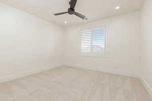 Empty room with light colored carpet, recessed lighting, and a ceiling fan