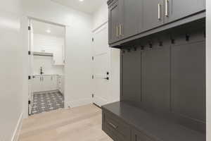 Mudroom with light wood-style floors and recessed lighting