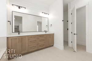 Full bathroom featuring double vanity and baseboards