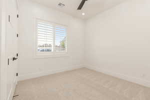Empty room featuring light carpet, recessed lighting, and a ceiling fan