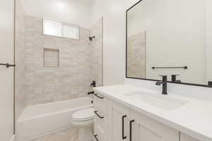 Bathroom featuring vanity, tub / shower combination, and light tile patterned floors