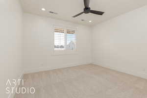 Carpeted empty room with ceiling fan and recessed lighting