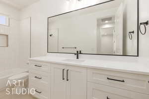 Bathroom featuring vanity and shower / tub combination