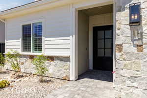 Entrance to property with stone siding