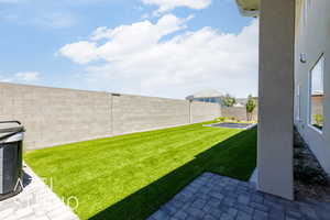 Fenced backyard with a patio area