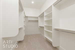 Spacious closet with light colored carpet