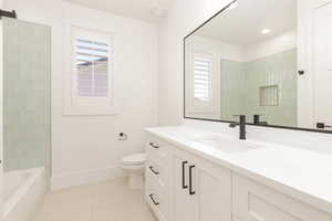 Bathroom featuring vanity, light tile patterned flooring, and shower / bath combination