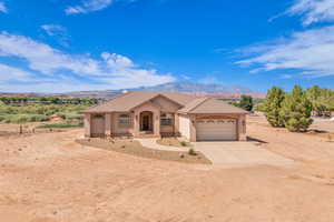 Mediterranean / spanish-style house with driveway, an attached garage, a mountain view, stucco siding, and a tile roof