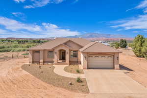 Mediterranean / spanish house featuring driveway, an attached garage, stucco siding, and a mountain view