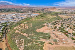 Aerial perspective of suburban area featuring property parcel outlined and a mountain backdrop