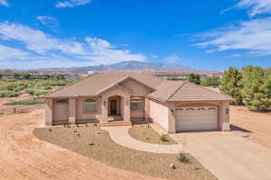 Mediterranean / spanish home with driveway, a garage, a mountain view, stucco siding, and a tile roof