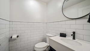 Bathroom with vanity and tile walls