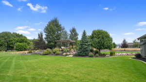 View of green lawn featuring a pergola