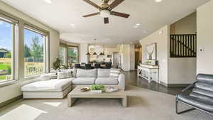 Living room with recessed lighting, ceiling fan, and a textured ceiling