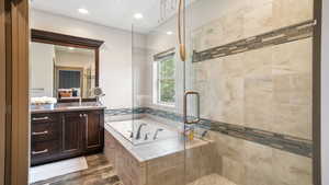 Full bathroom with a stall shower, a bath, vanity, and recessed lighting