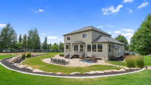 Back of property featuring stucco siding, a patio, and an outdoor hangout area