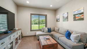 Living area with carpet and recessed lighting