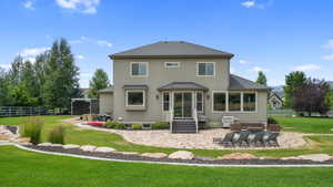 Back of property with roof with shingles, a patio area, and stucco siding