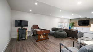 Living area featuring recessed lighting and dark wood-style floors