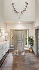 Foyer entrance featuring wood-type flooring and baseboards