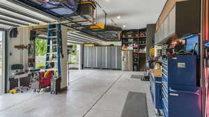 Garage with stainless steel refrigerator with ice dispenser