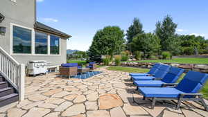 View of patio / terrace with area for grilling, a mountain view, and an outdoor hangout area