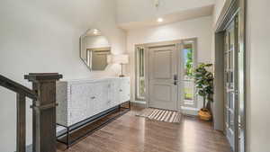 Entryway with wood finished floors and recessed lighting