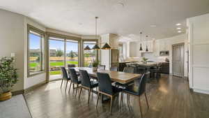 Dining space with recessed lighting, dark wood-style flooring, and a textured ceiling