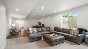 Carpeted living area featuring baseboards and recessed lighting